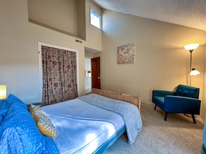 Queen bed, vaulted ceilings, and sliding door to deck, provides peaceful retreat