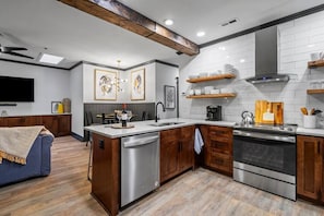 Hickory kitchen cabinets and weathered beams bring back the original late 1800's feel.
