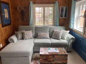 Partial of living room w/ brand new comfy queen sofa w/ queen sleeper option!