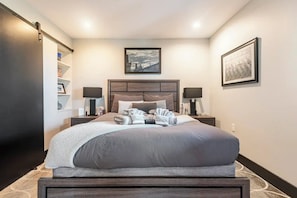 Close up shot of Queen bedroom with barn door closet