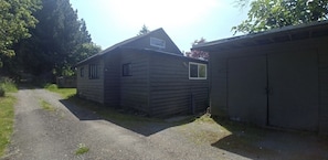 View of home from the lane and there is parking in front of the shed