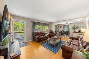 Living room with view towards front yard and dining room.