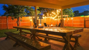 Host a family barbecue or dinner with this massive outdoor picnic table!