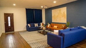 Spacious living room has three couches, perfect for the whole family to sit on!