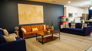 Spacious living room has three couches, perfect for the whole family to sit on!