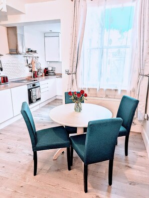 Dining area and kitchen with large windows and natural light