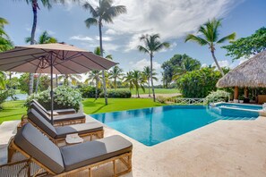 Pool area with hot tub, lake and golf views, outdoor living and a large garden