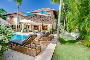 Pool area with hot tub, lake and golf views, outdoor living and a large garden