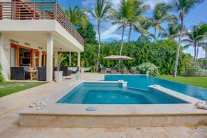 Pool area with hot tub, lake and golf views, outdoor living and a large garden