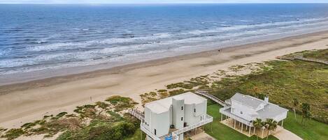 This beachfront home sits closer to the beach than the other homes allowing a sweeping view of the beach.