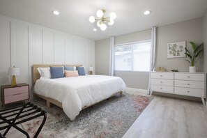 2nd King bedroom with decorative board and batten wall, large closet, dresser