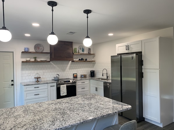 Kitchen with granite counters and Samsung appliances