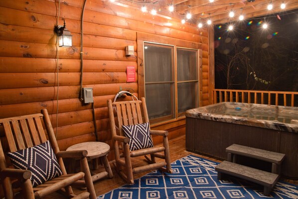 The hot tub is on the lower deck, the lights come on at night. 