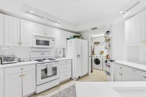 Fully equipped kitchen and laundry room.