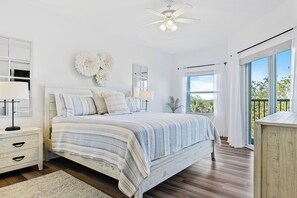 Master bedroom offers a king bed, sliders to balcony, and ensuite bath.