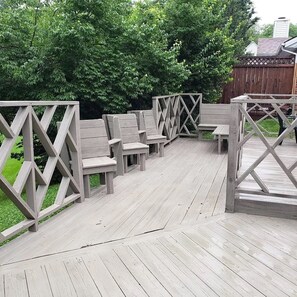 Private deck overlooking large backyard.