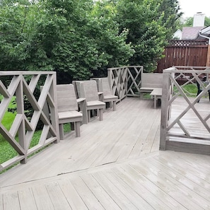 Private deck overlooking large backyard.