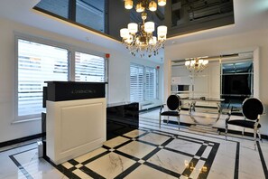Resprezsentative lobby with elegant chairs and reception area.