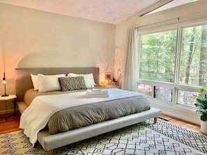 This bedroom also features a king size bed - this time on a West Elm platform bed frame. With spacious picture windows looking in to the backyard and a couch in this room for lounging, it's spacious and peaceful -- and perfect for napping!