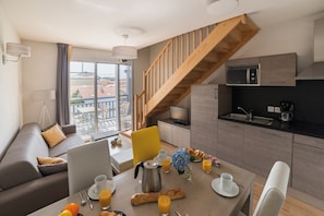 Modern kitchenette and bright living area. This unit may be available as a duplex!