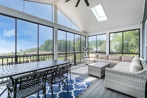 The screened-in porch with water views stays warm in the winter and cool in the summer.