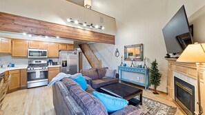 living room with loft above