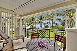 Ocean and pool view lanai! - Watch the whales breach from your lanai! There is a dining table with 4 chairs, a chaise lounge, and a side table