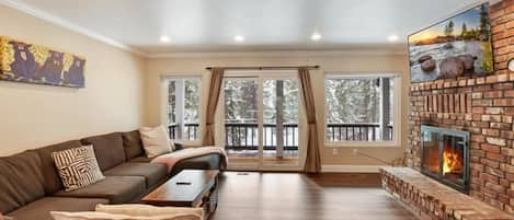 Living area with fireplace, deck, and Smart TV