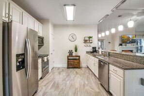 Stainless Steel appliances in well-equipped kitchen.