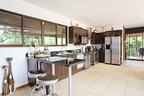Open concept kitchen with stainless steel appliances and granite countertop.