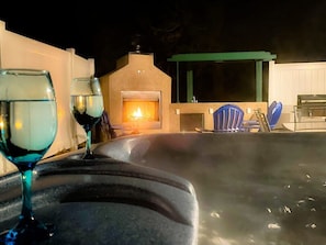 Private patio with fireplace and hot tub