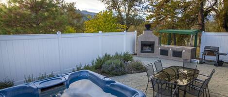 Private patio with fireplace, hot tub, and BBQ