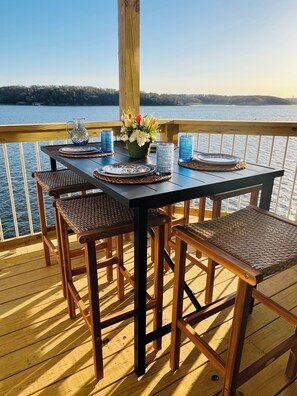 New covered deck with bar height seating. Beautiful view of the main channel