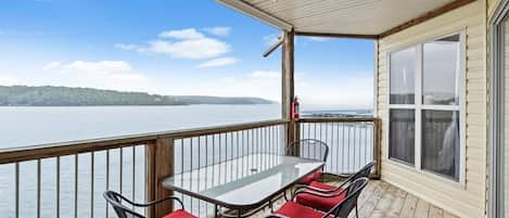 Large covered deck with seating, main channel lake view and propane grill