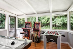 A game room with arcade games, foosball, and air hockey for fun and memories! 