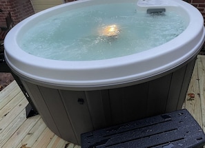 A warm hot tub with jets ready to melt the stresses of life away. 