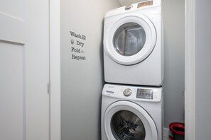 Full size washer and dryer with supplies for your use in the home.
