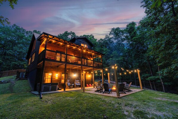 Enjoy a large fenced-in yard with a new fire pit, grill, hot tub, and swings!   