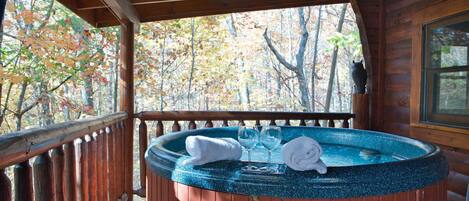 Private hot tub w/ view of the woods and privacy curtains