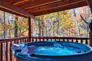 Private hot tub w/ view of the woods and privacy curtains