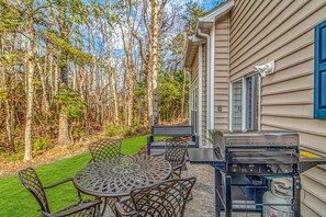 Patio with gas grill. Sit, dine, relax. Enjoy grove of tall trees and nature.