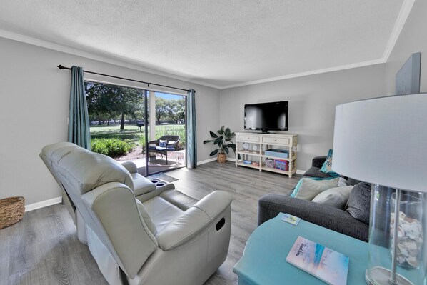 Spacious living room with cable TV, games, books, and a sofa bed.