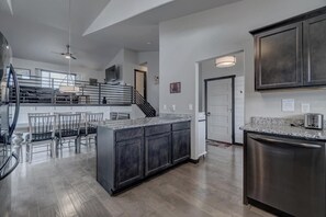 View from kitchen to dining area and upper living room area