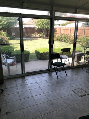 Screened in porch enjoy looking at the fenced in backyard.