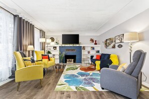 Modern conveniences with mid century charm through this lovely cottage, starting with this living room that you see just as you walk in!