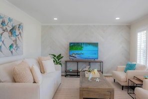 Beautifully remodeled family room has the comfiest couch to curl up on! 
