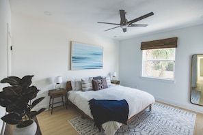 The west master suite with a king bed and one of my personal photographs.