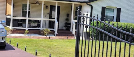 Gated Driveway and Front Porch w/chairs and ceiling fan