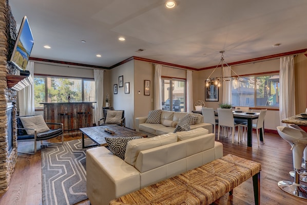 Living area with contemporary furniture, flat screen tv, and fireplace