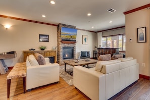 Living area with contemporary furniture, flat screen tv, fireplace and shuffleboard